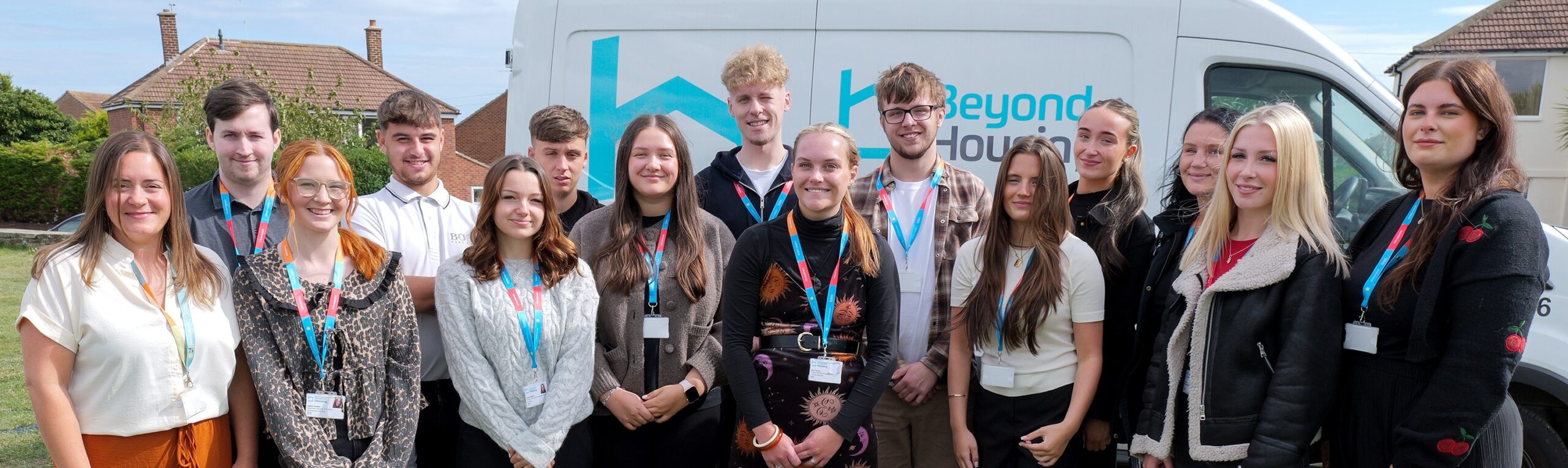 15 people stood in front of a white van