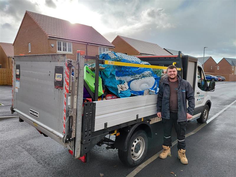 Person stood next to a tipper van 