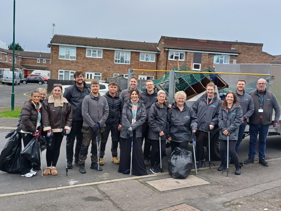 A group of people with litter pickers stood in front of a van.