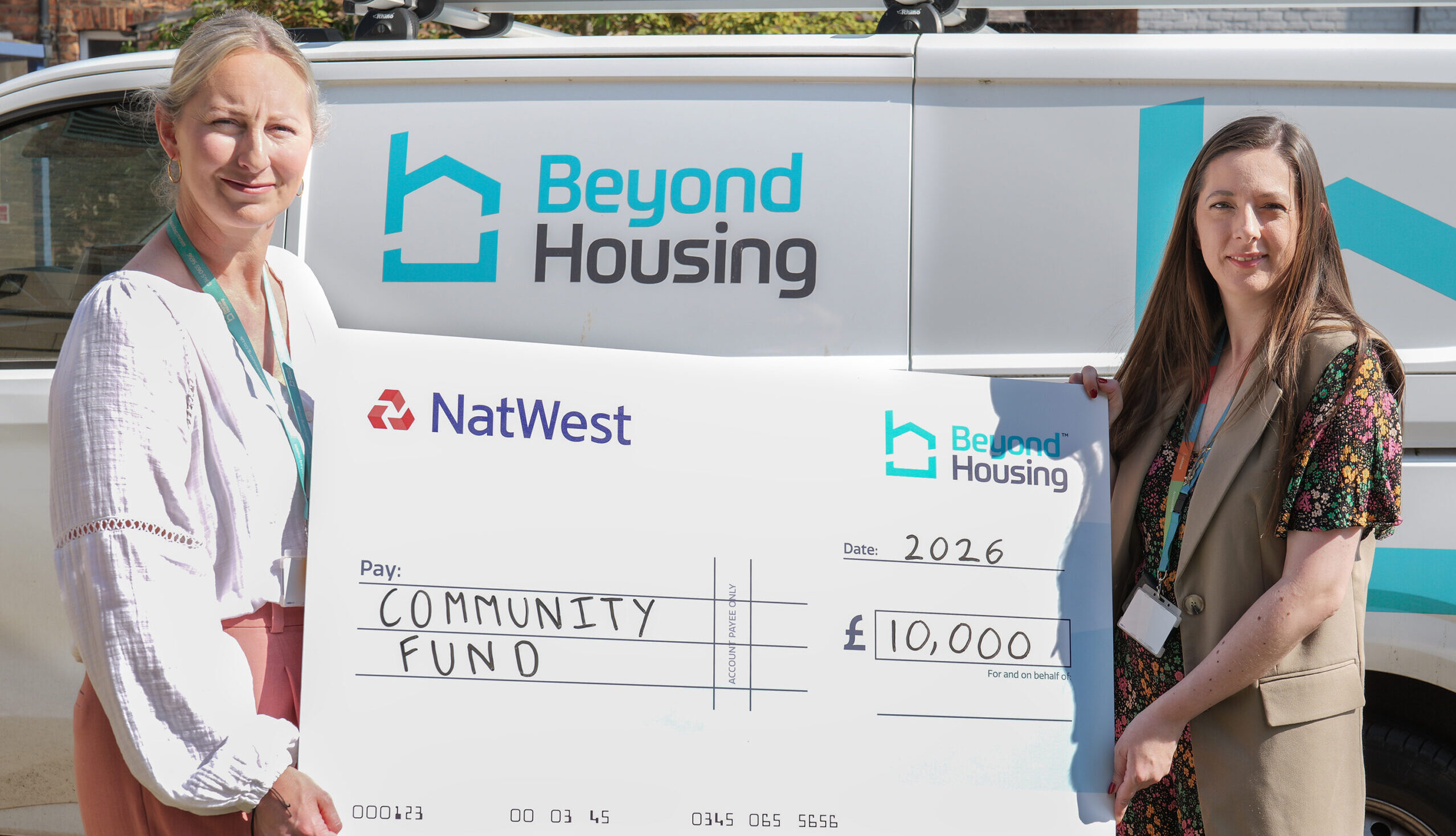 Two people holding an oversized cheque